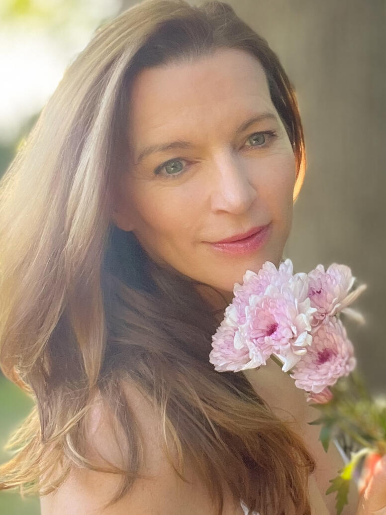 Julia Robertson smelling flowers